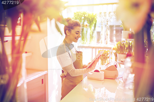 Image of woman with tablet pc computer at flower shop