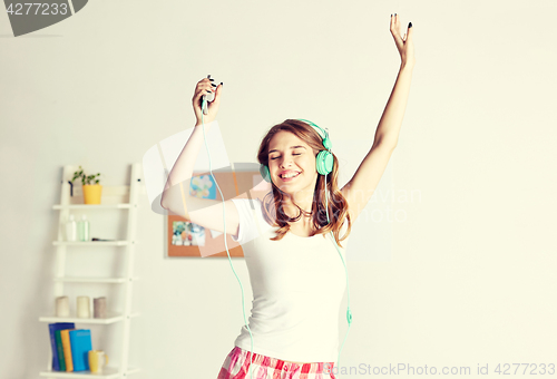 Image of happy woman in headphones ihaving fun at home