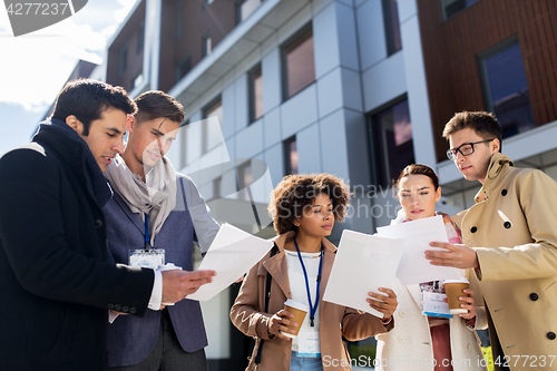 Image of international business team with papers in city