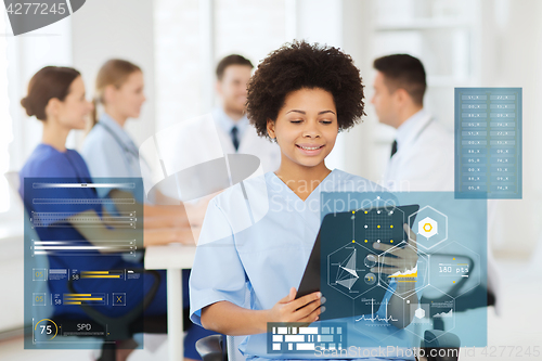 Image of happy doctor with clipboard at hospital