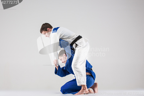 Image of The two judokas fighters fighting men