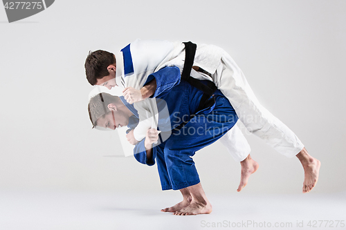 Image of The two judokas fighters fighting men