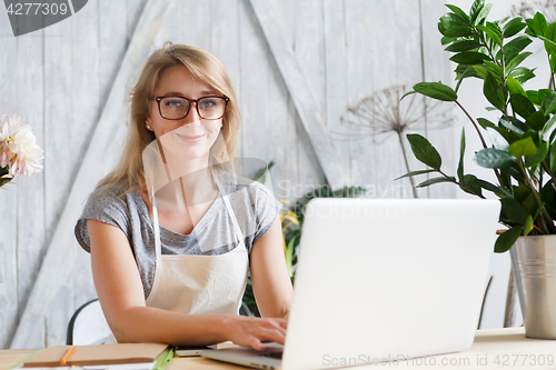 Image of Woman florist sitting at table