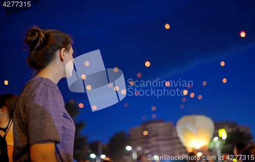 Image of Teen Girl  watching paper lantern