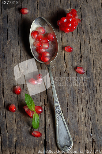 Image of Ripe pomegranate and spoon 