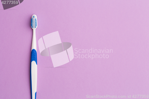 Image of Toothbrush on empty pink background