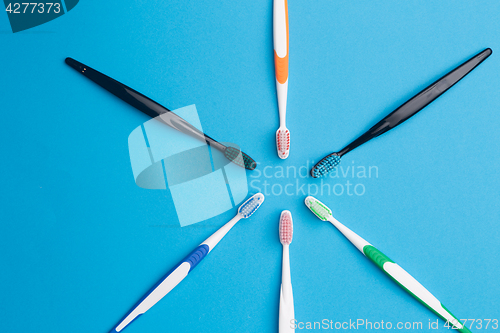 Image of Multi-colored toothbrushes arranged in circle