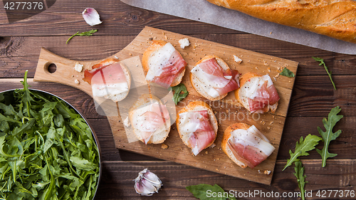 Image of Bread , bacon on cutting board