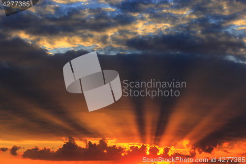 Image of summer sunset with dark sky and sun