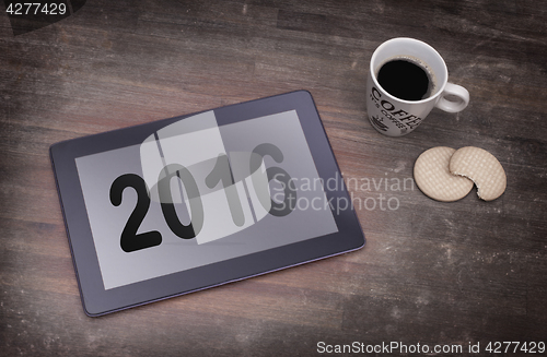 Image of Tablet touch computer gadget on wooden table - 2016