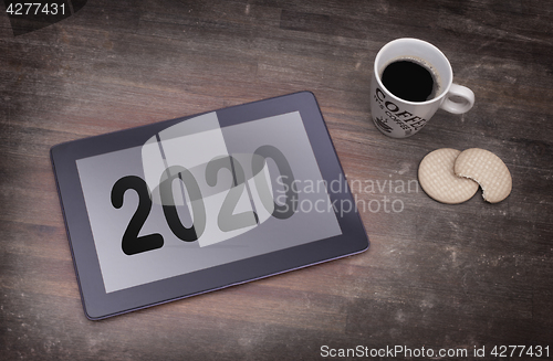 Image of Tablet touch computer gadget on wooden table - 2020