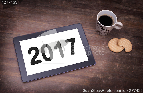 Image of Tablet touch computer gadget on wooden table - 2017