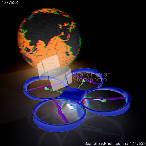 Image of Quadrocopter Drone with Earth Globe and remote controller on a w