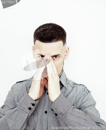 Image of Portrait of a smart serious young man standing against white background. Emotional concept for gesture 