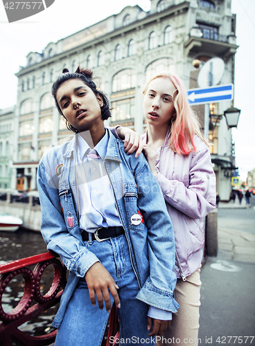 Image of Two teenage girls infront of university building smiling, having fun, lifestyle real people concept 