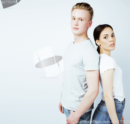 Image of young pretty teenage couple, hipster guy with his asian girlfriend happy smiling and hugging isolated on white background, lifestyle people concept close up, diverse nations real relationship