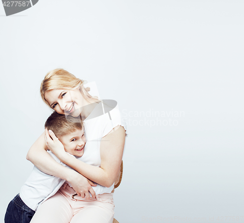 Image of young modern blond curly mother with cute son together happy smiling family posing cheerful on white background, lifestyle people concept, sister and brother friends 