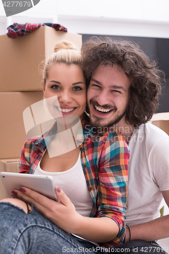 Image of young couple moving  in new house