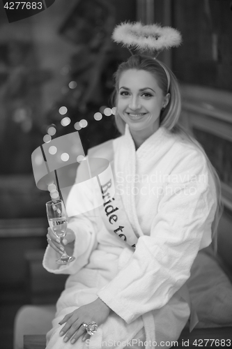 Image of woman drinking champagne at spa