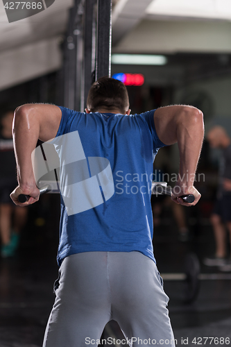 Image of man doing exercises parallel bars