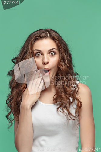 Image of Portrait of young woman with shocked facial expression