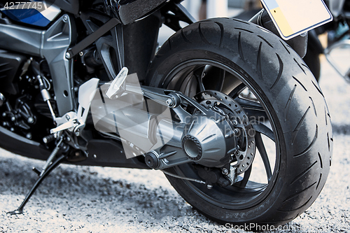 Image of Motorcycle luxury items close-up: headlights, shock absorber, wheel, wing, toning.