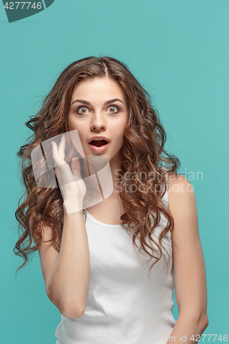 Image of Portrait of young woman with shocked facial expression