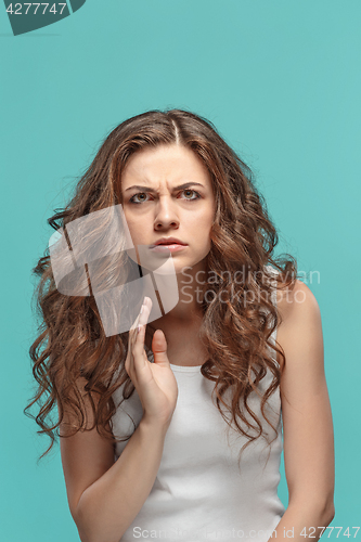 Image of Portrait of young woman with shocked facial expression