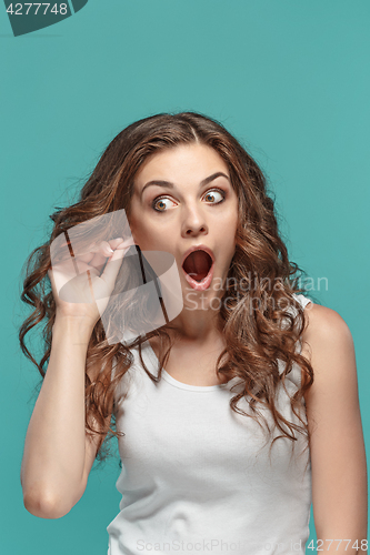 Image of Portrait of young woman with shocked facial expression