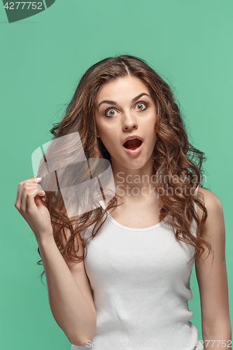 Image of Portrait of young woman with shocked facial expression