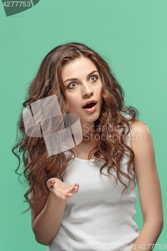 Image of Portrait of young woman with shocked facial expression