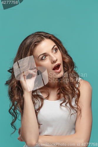 Image of Portrait of young woman with shocked facial expression