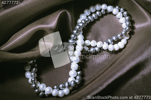 Image of Natural Pearl Necklaces On Silk Background