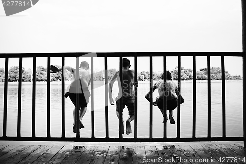 Image of Children jumping from waterfront