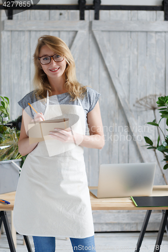 Image of Young blonde florist with glasses