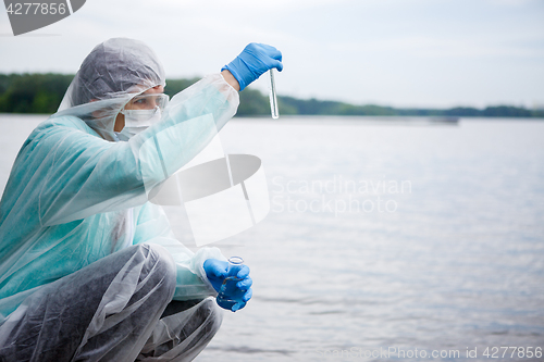 Image of Biologist takes water for examination
