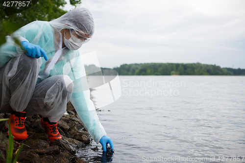 Image of Young biologist takes water samples