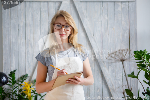 Image of Woman florist with glasses , apron