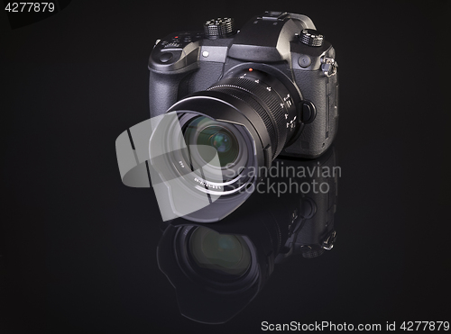 Image of dslr photocamera on black background