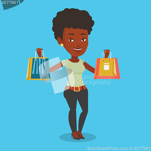 Image of Happy woman holding shopping bags.