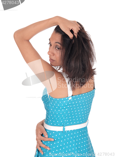 Image of Hispanic woman in blue dress from the back.