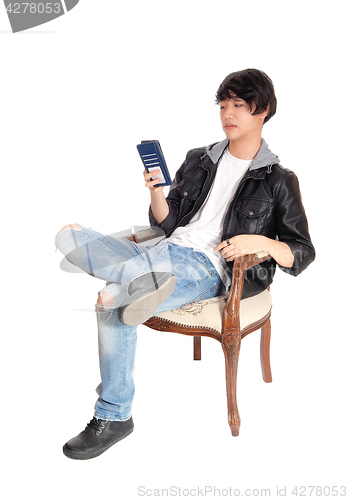 Image of Asian man talking on his cellphone.