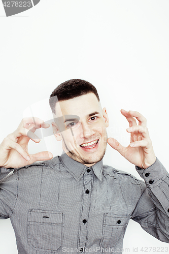 Image of Portrait of a smart serious young man standing against white background. Emotional concept for gesture 