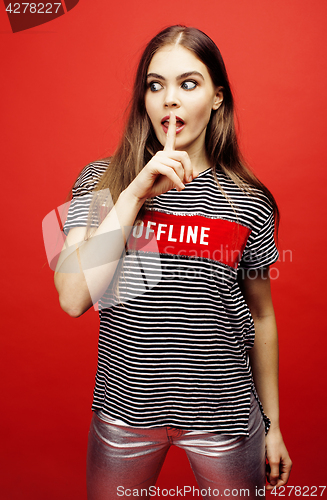 Image of young pretty emitonal posing teenage girl on bright red background, happy smiling lifestyle people concept