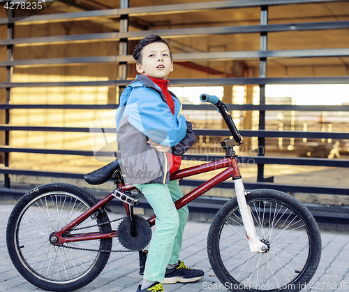 Image of young kid on cool bmx bicycle riding outside, lifestyle people concept 