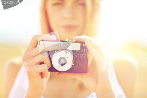 Image of close up of woman photographing with film camera