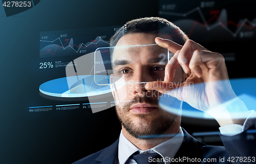 Image of businessman with smartphone and virtual charts