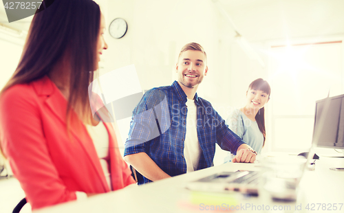 Image of happy international creative team at office