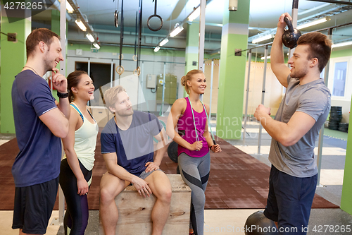 Image of group of friends with sports equipment in gym