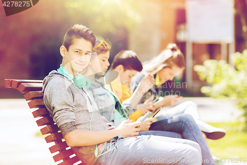 Image of happy teenage boy with tablet pc and headphones